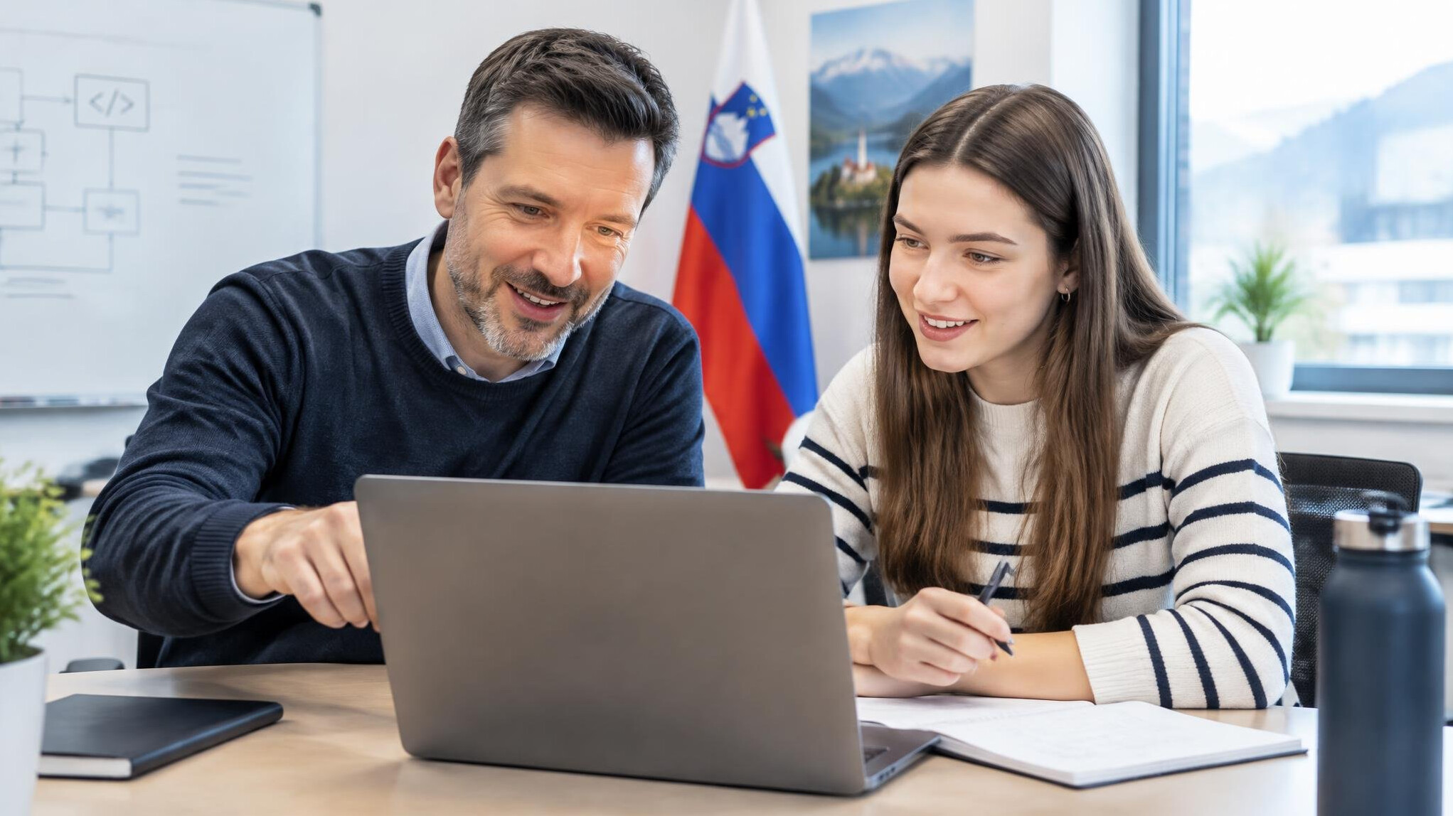 Mentor and student discussing a software project on a laptop