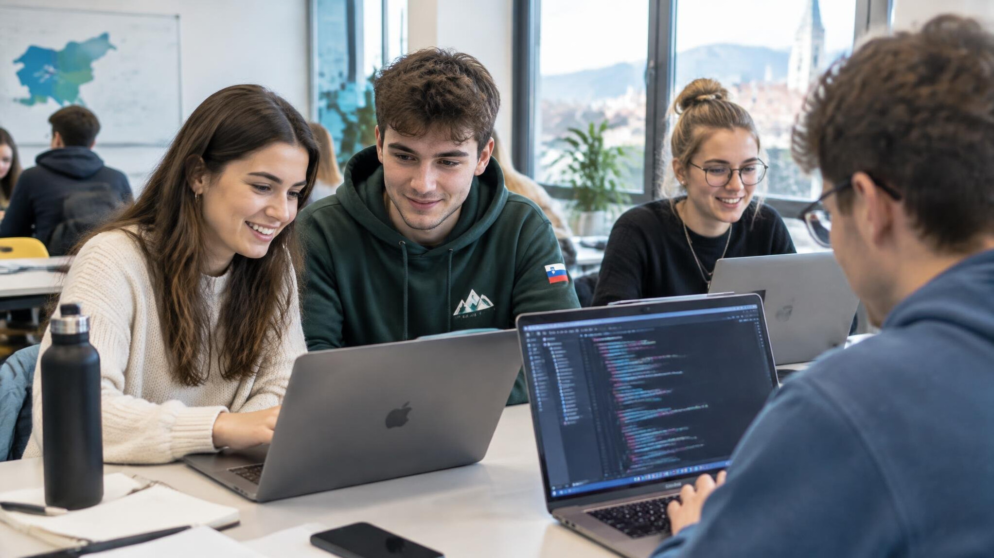 Students working on laptops with code in a modern classroom