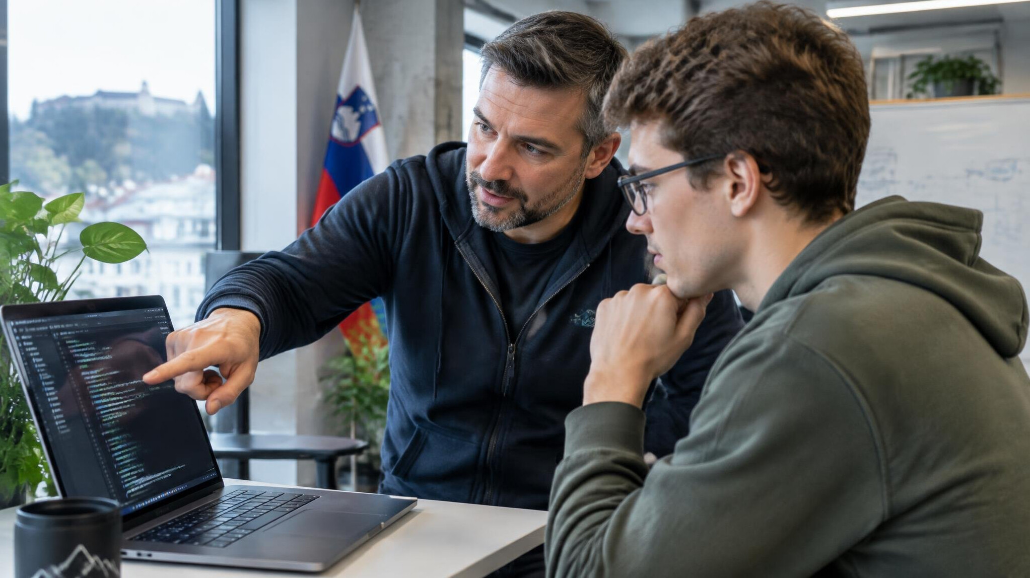 Senior developer mentoring a younger colleague